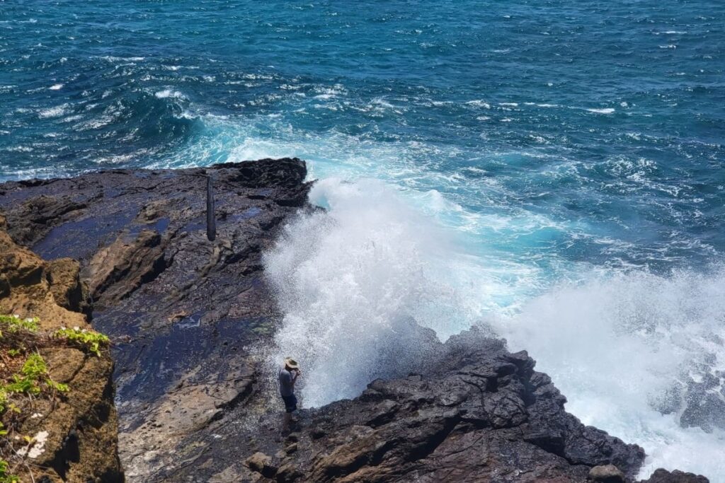 Waves breaking over the lava rock at Halona Blowhole on Oahu's southeast shore