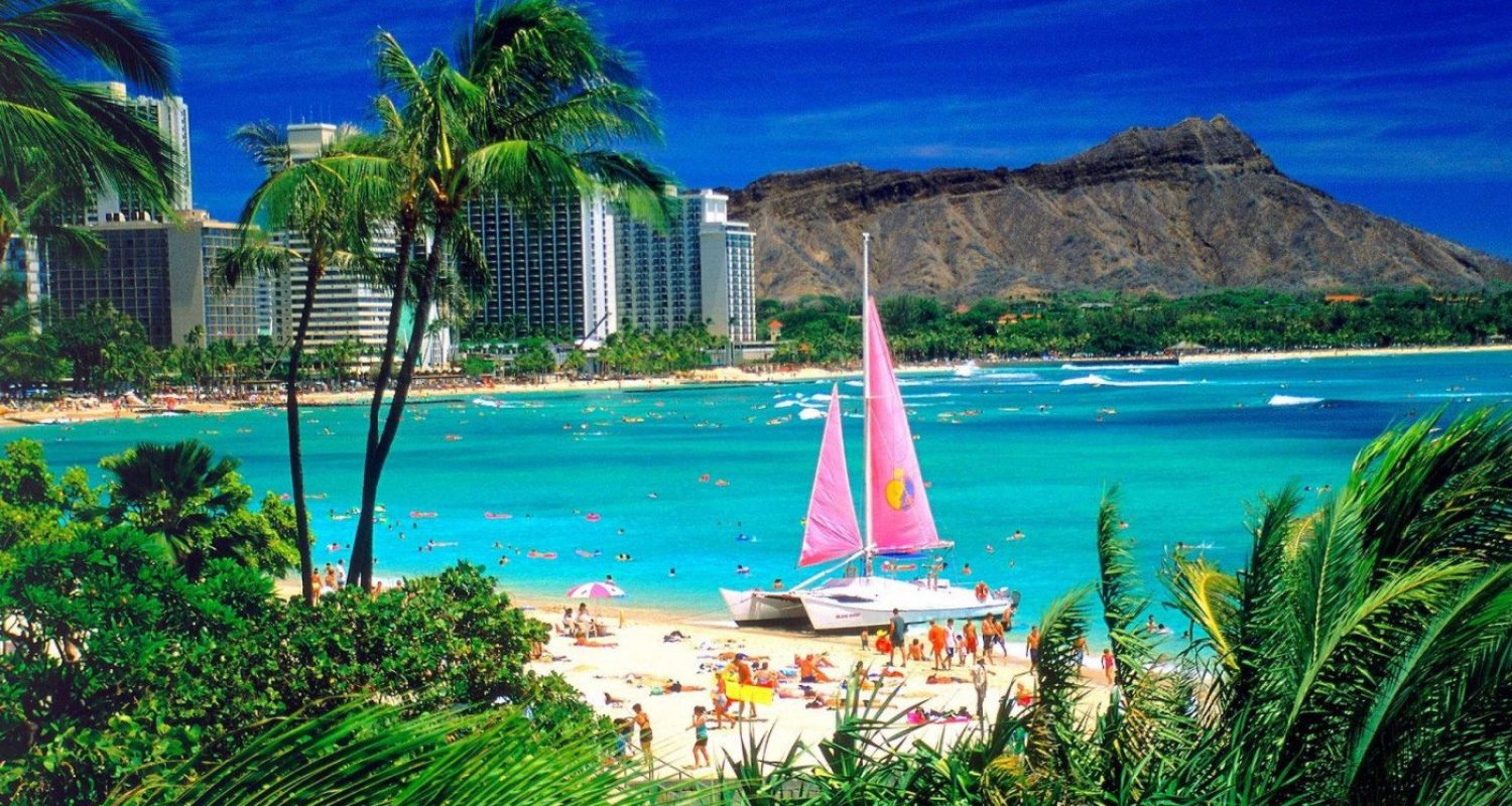 Waikiki Beach and Diamond Head with a catamaran offshore