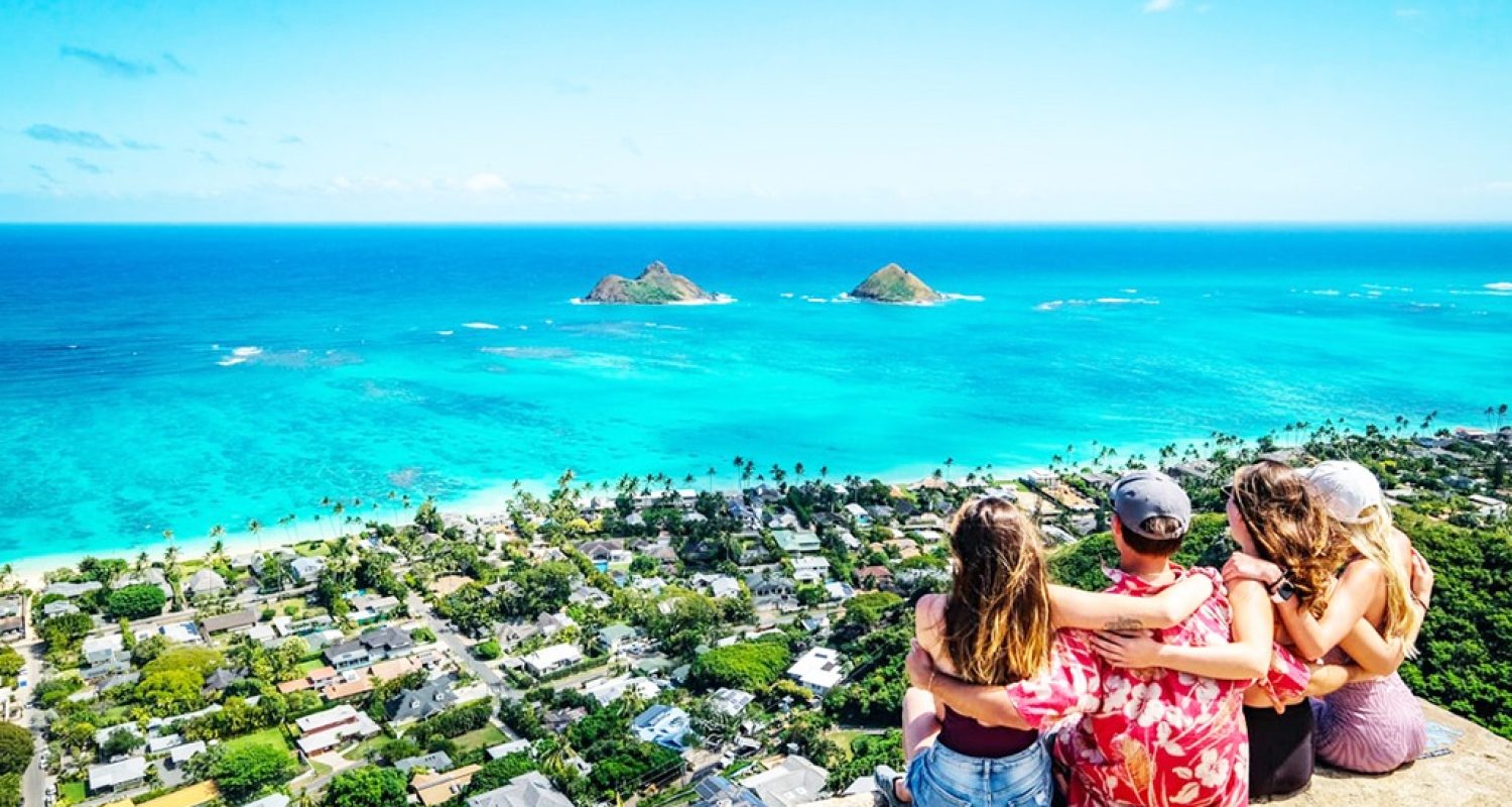 Friends looking out over Lanikai and the Mokulua Islands on Oahu's windward side
