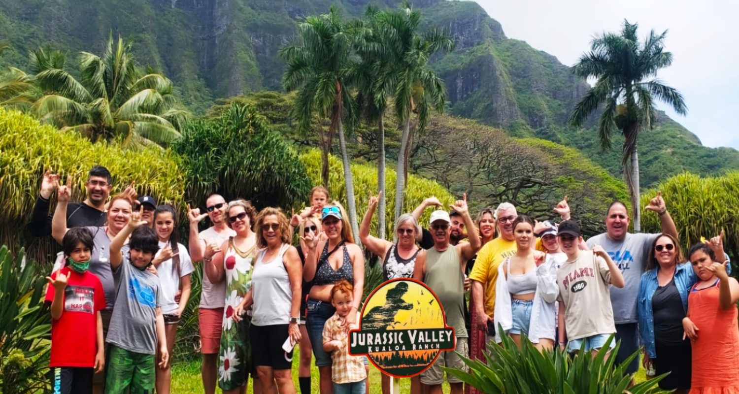 A large tour group in front of the Koʻolau Mountains at Kualoa